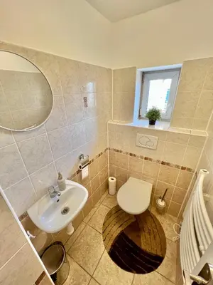 a bathroom with a toilet and a sink at Cozy Studio with Prague panorama view in Prague