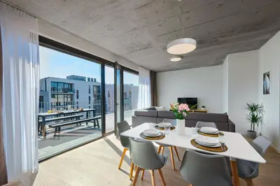 a living room with a white table and chairs at DownTown Suites Andel in Prague