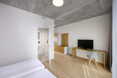 a bedroom with a bed and a television in it at DownTown Suites Andel in Prague