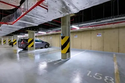 a parking lot with cars parked in a parking garage at DownTown Suites Andel in Prague
