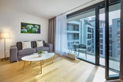 a living room with a couch and a table at DownTown Suites Andel in Prague