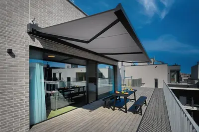 a patio with a table and chairs on a balcony at DownTown Suites Andel in Prague