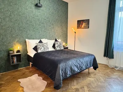 a bedroom with a bed with pillows on it at Cinematic Apartment with Pool Table & Cinema room in the heart of Prague in Prague