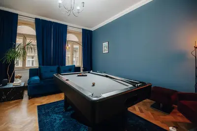 a living room with a pool table and blue walls at Cinematic Apartment with Pool Table & Cinema room in the heart of Prague in Prague