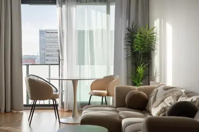 a living room with a couch and chairs and a table at Fresh All-in Apartment Prague in Prague