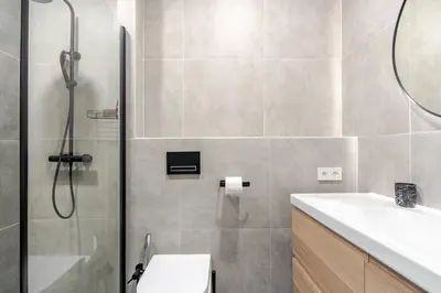a bathroom with a shower and a toilet and a sink at Place of Grace - A Few Steps From the Museum in Prague