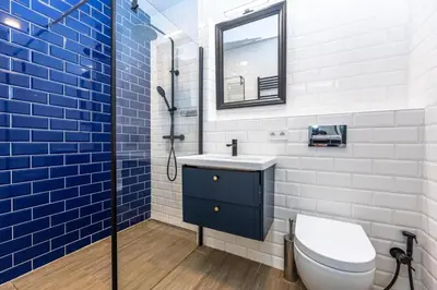 a bathroom with a toilet and a sink and a mirror at Place of Grace - A Few Steps From the Museum in Prague