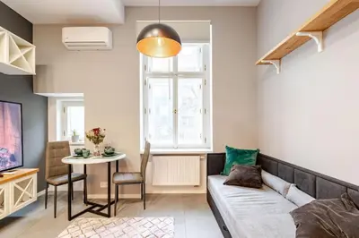 a living room with a couch and a table at Place of Grace - A Few Steps From the Museum in Prague