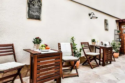 a patio with chairs and a table with fruit on it at Accommodation Smečky 14 in Prague