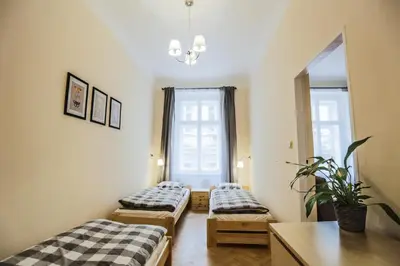 a room with two beds and a mirror at Accommodation Smečky 14 in Prague