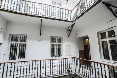 a staircase in a white house with white walls at Accommodation Smečky 14 in Prague