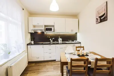 a kitchen and dining room with a table and chairs at Accommodation Smečky 14 in Prague