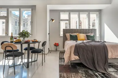 a bedroom with a bed and a table with chairs at The Grand Krocínova Loft - Golden Bond Retreat in Prague
