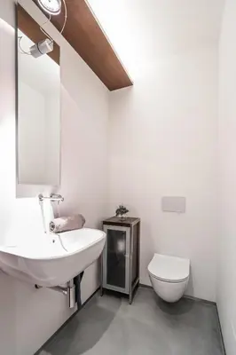 a white bathroom with a sink and a toilet at The Grand Krocínova Loft - Golden Bond Retreat in Prague