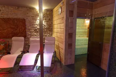 a room with a group of chairs and a shower at Pension U Hastrmana in Prague