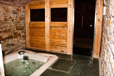 a bath tub in a room with a window at Pension U Hastrmana in Prague