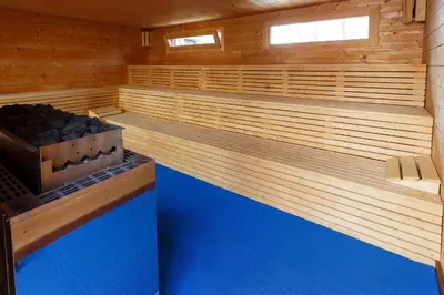a sauna with a blue floor and wooden walls at Pension U Hastrmana in Prague