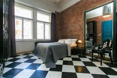 a bedroom with a bed and a checkered floor at OLD TOWN - 4 Room 2 Bathroom Apartment in Prague