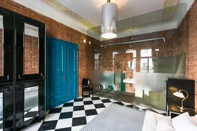 a bedroom with a blue door and a checkered floor at OLD TOWN - 4 Room 2 Bathroom Apartment in Prague