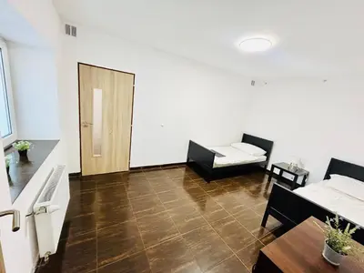 a living room with a couch and a table at Villa Apartments with Free Parking Prague 5 in Prague