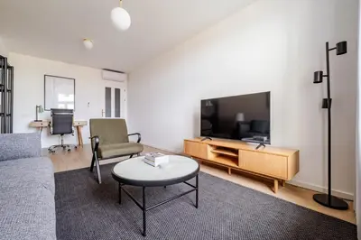 a living room with a couch and a tv at Blueground Prague 2 furnished Náměstí Míru PRG-44 in Prague