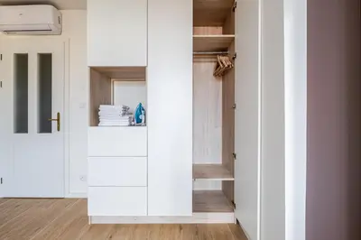 a room with white cabinets and a closet at Blueground Prague 2 furnished Náměstí Míru PRG-44 in Prague