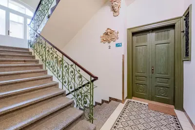 a staircase with a green door in a house at Blueground Prague 2 furnished Náměstí Míru PRG-44 in Prague