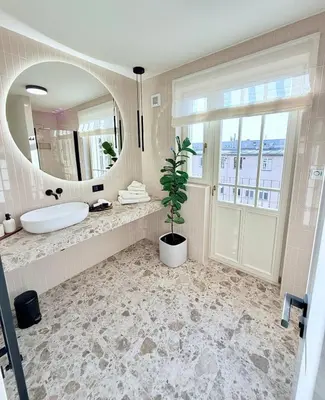 a bathroom with a large mirror and a sink at Luxury New Apartment with Balcony Steps from Wenceslas Square in Prague