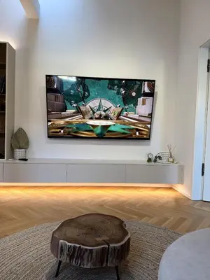a living room with a flat screen tv on a wall at Luxury New Apartment with Balcony Steps from Wenceslas Square in Prague