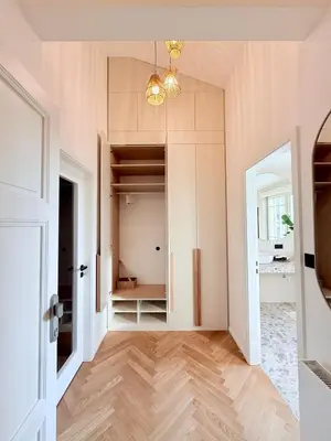 an empty room with a hallway with a table at Luxury New Apartment with Balcony Steps from Wenceslas Square in Prague
