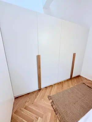 a room with white cabinets and a rug at Luxury New Apartment with Balcony Steps from Wenceslas Square in Prague