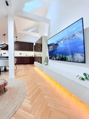 a living room with a large flat screen tv on a wall at Luxury New Apartment with Balcony Steps from Wenceslas Square in Prague