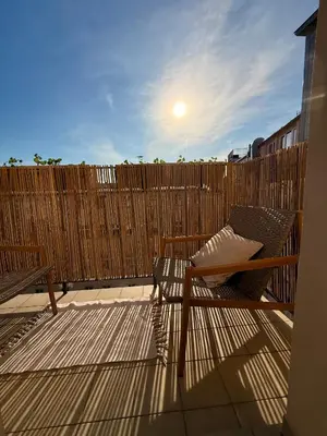 a patio with two benches and a wooden fence at Luxury New Apartment with Balcony Steps from Wenceslas Square in Prague
