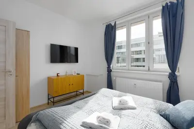 a bedroom with a bed with towels on it at 2 bedroom apartment with a terrace near the metro in Prague