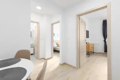 a room with a table and chairs and a mirror at 2 bedroom apartment with a terrace near the metro in Prague