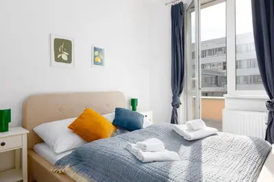 a bedroom with a bed with towels on it at 2 bedroom apartment with a terrace near the metro in Prague