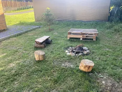 a group of logs and a fire in a yard at Domeček Pikovice in Píkovice