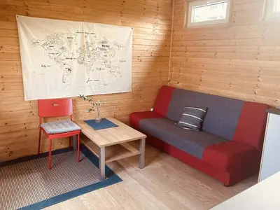 a room with a couch and a table and a map at Domeček Pikovice in Píkovice
