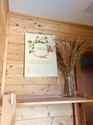 a card on a wall with a vase on a shelf at Domeček Pikovice in Píkovice