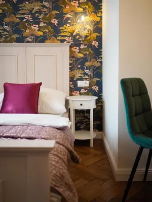 a bedroom with a bed and a chair and a table at Stupartska Grand Residence in Prague