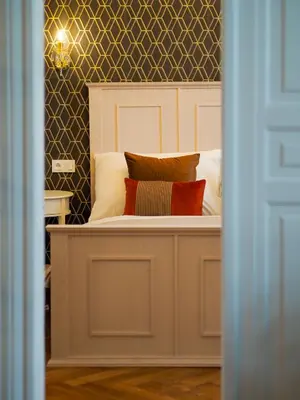a bed with pillows on top of it at Stupartska Grand Residence in Prague