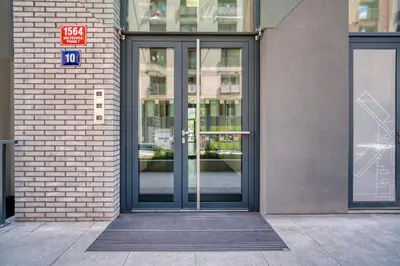 an entrance to a building with a revolving door at Czech TESLA apartment by Rentez in Prague