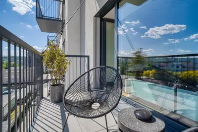 a balcony with a table and a chair on a balcony at Czech TESLA apartment by Rentez in Prague