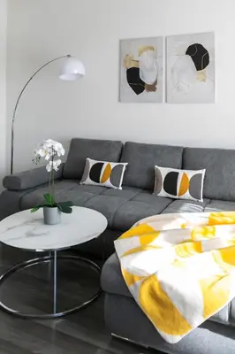 a living room with a couch and a table at The Loft Holešovice in Prague