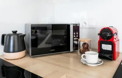 a microwave sitting on top of a kitchen counter at The Loft Holešovice in Prague