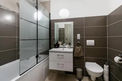 a bathroom with a toilet and a sink and a shower at The Loft Holešovice in Prague
