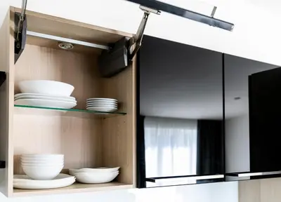 a cabinet with plates and bowls in it at The Loft Holešovice in Prague