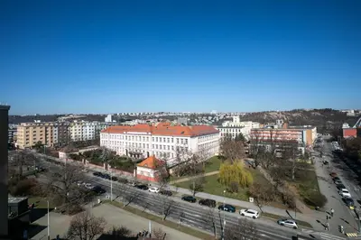 a view of a city with cars and buildings at The Loft Holešovice in Prague