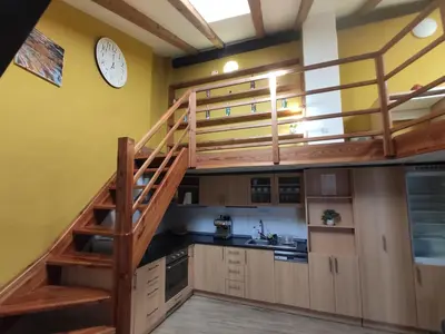 a kitchen with a loft bed and a staircase at CozyGem House 2