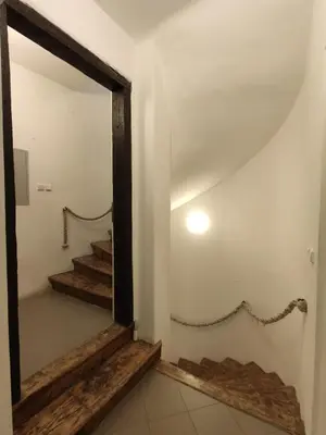 a hallway with a mirror and stairs in a house at CozyGem House 2